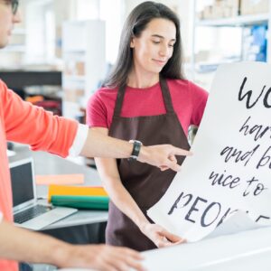 Coworking colleagues with printed poster