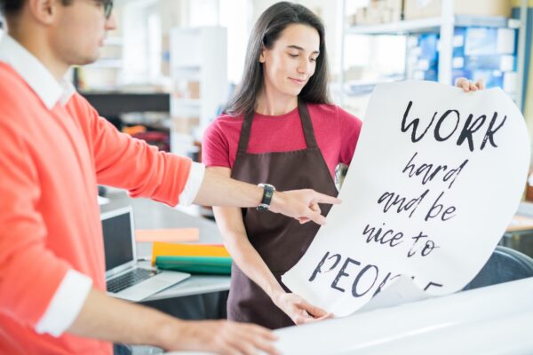 Coworking colleagues with printed poster