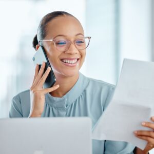 Happy business woman talking on a phone call, discussing contract with a client or colleague. Femal