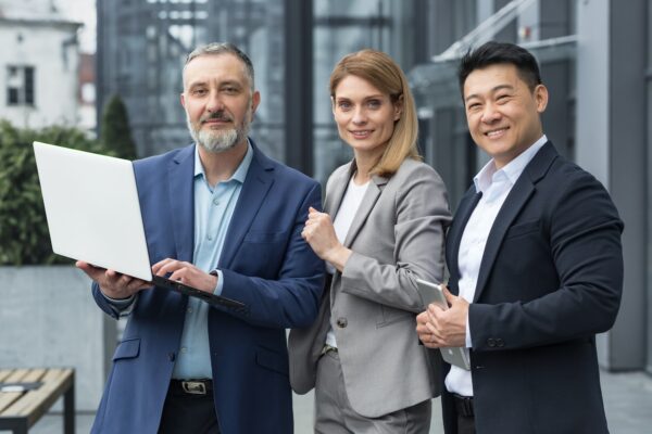 Portrait dream team IT specialists professionals team leaders outside office building looking at