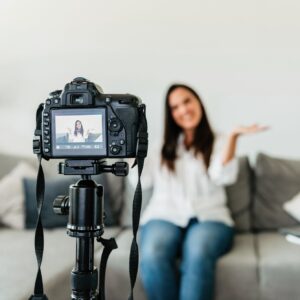 Selective focus photo of a happy female making a video