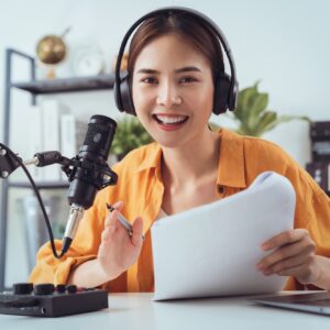 woman use microphones wear headphones with laptop record podcast interview for radio.