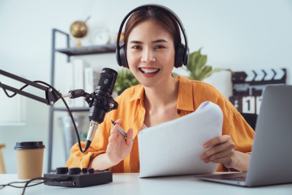 woman use microphones wear headphones with laptop record podcast interview for radio.